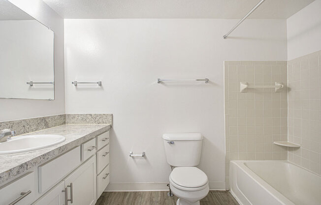 an upgraded bathroom with a sink toilet and a bath tub at North Pointe Apartments in Elkhart, IN