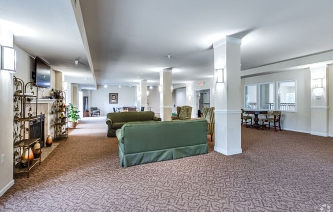 a large living room with couches and a fireplace