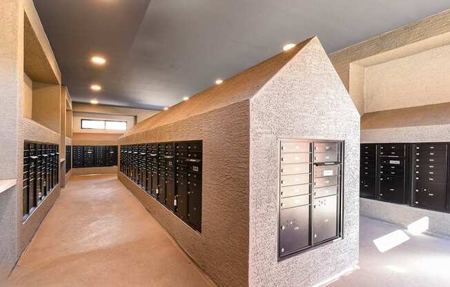 A long hallway with a series of lockers on the wall.