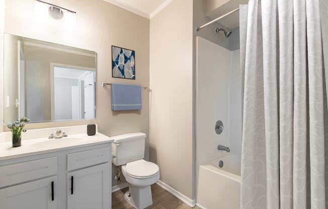 a bathroom with a toilet sink and shower