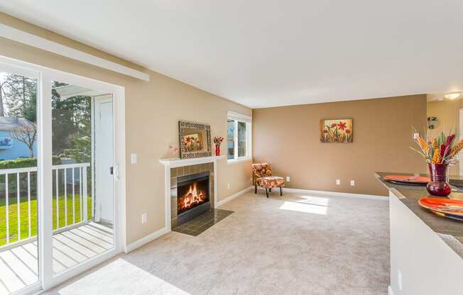 a living room with a fireplace and a balcony at Springfield, Renton, WA 98055