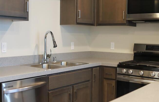 kitchen with a sink oven stove and microwave at Loma Villas Apartments, California, 92408