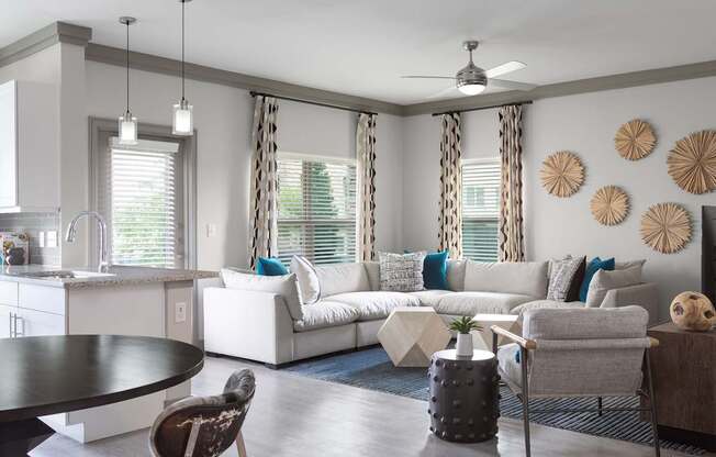 A modern living room with a white sofa and a black table.