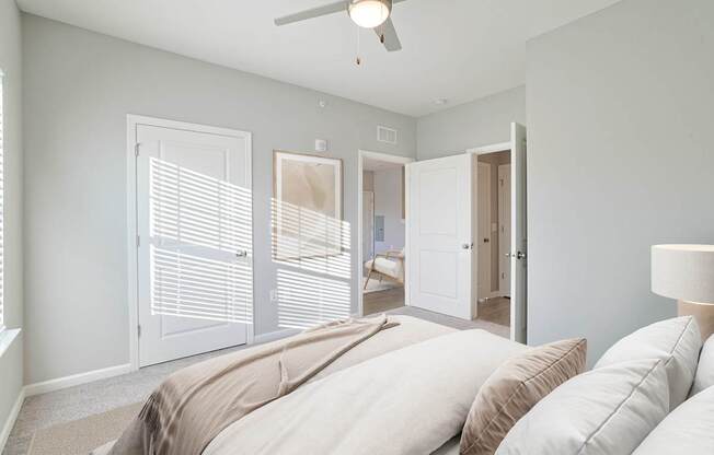 A room with a ceiling fan and two doors.