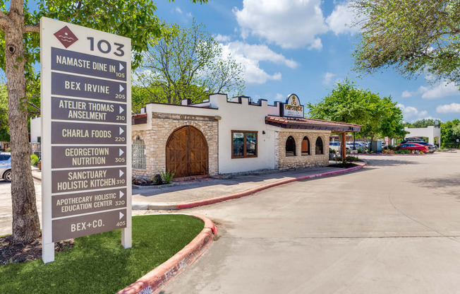 a sign in front of a taco restaurant with a parking lot