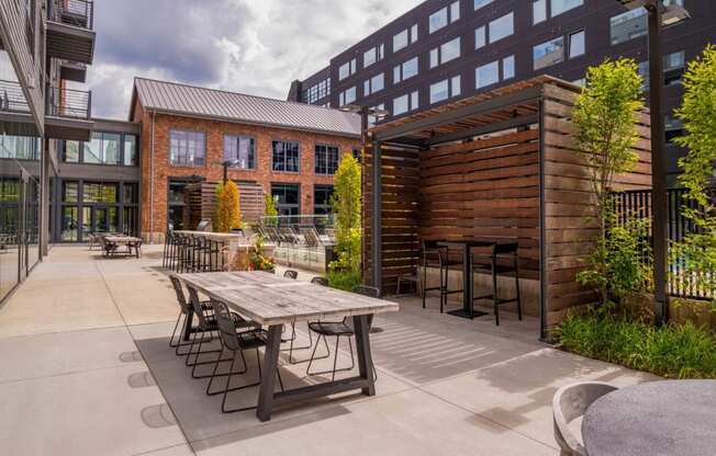 a patio with a table and chairs outside of a building