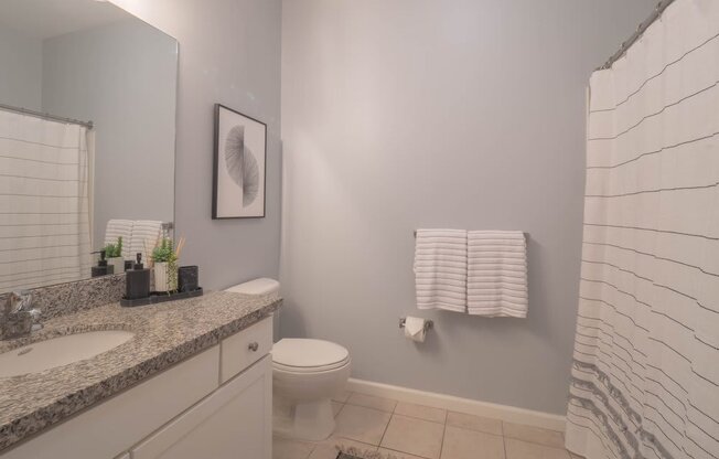 a bathroom with a toilet sink and shower