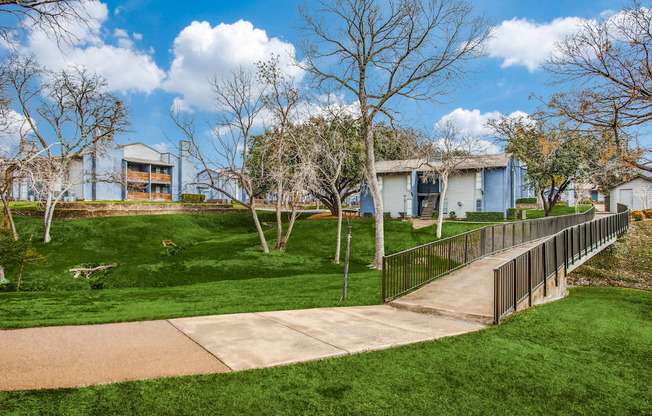 a sidewalk leading to a house in a park