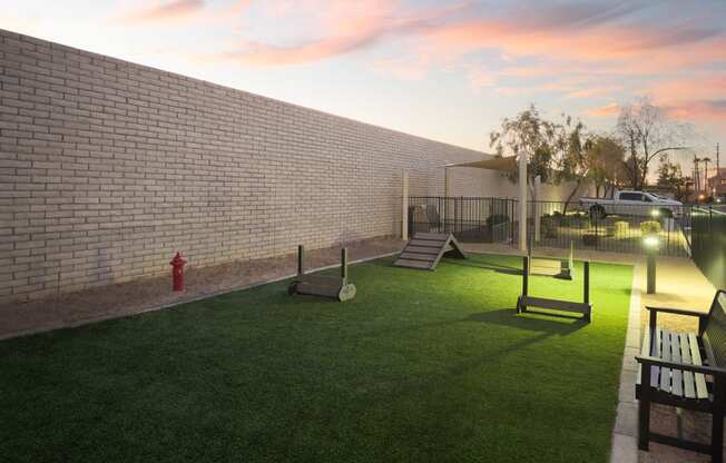 a backyard with a fire hydrant and swings and a play yard