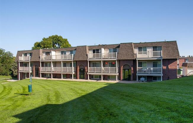 a large lawn in front of an apartment building