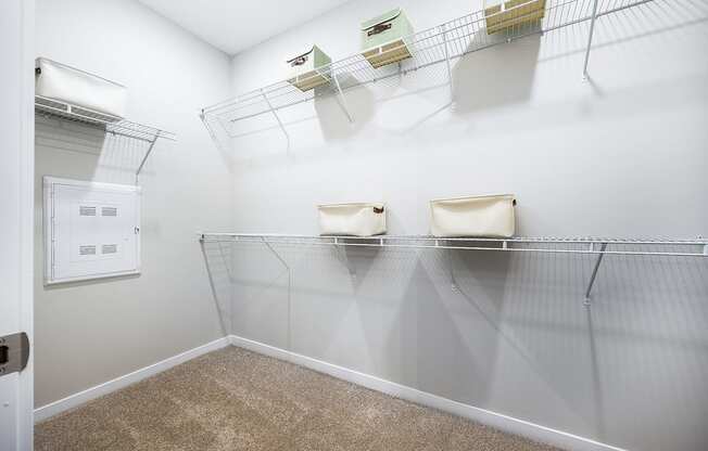 a spacious closet with shelves and a dryer in the corner of the room