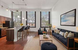 A living room with a blue couch and a coffee table.