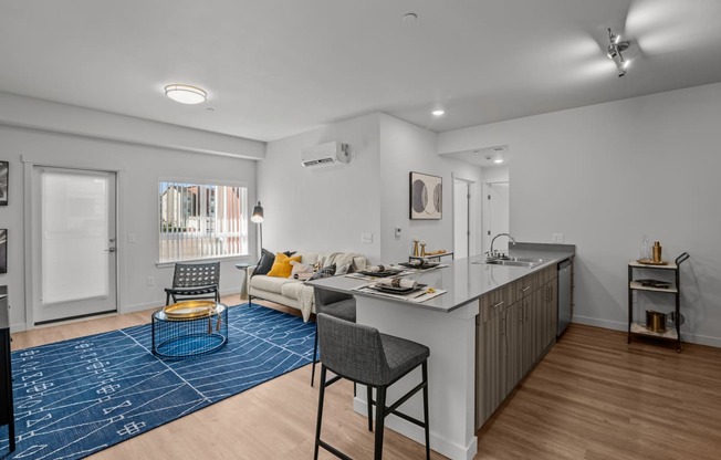 a living room with a kitchen counter and a couch