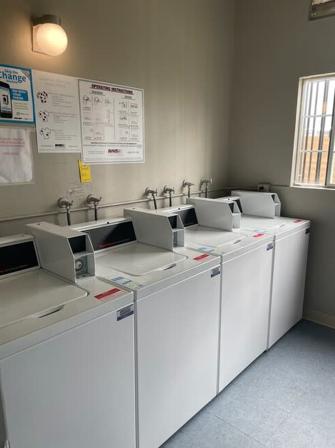 a row of white washing machines sitting next to each other at Fiesta Apts, Lompoc, 93436