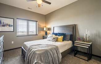 Bedroom with ceiling fan and natural lighting at 360 at Jordan West best new apartments West Des Moines IA 50266
