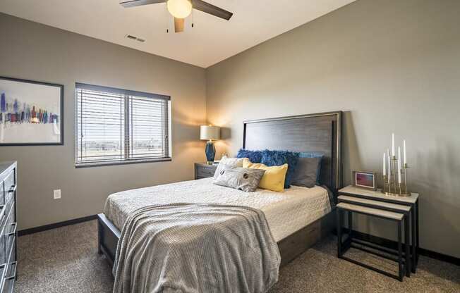 Bedroom with ceiling fan and natural lighting at 360 at Jordan West best new apartments West Des Moines IA 50266