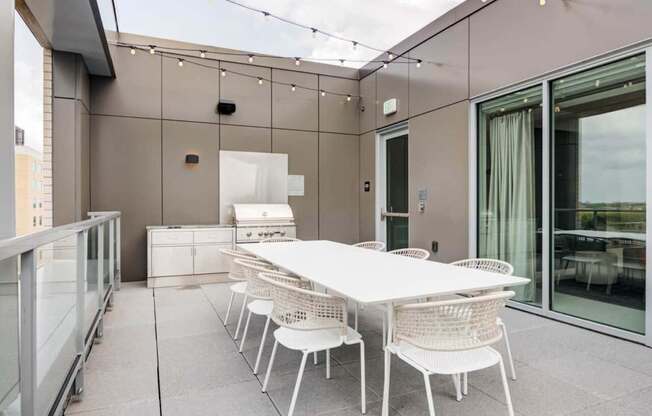 A white table and chairs are set up on a patio.