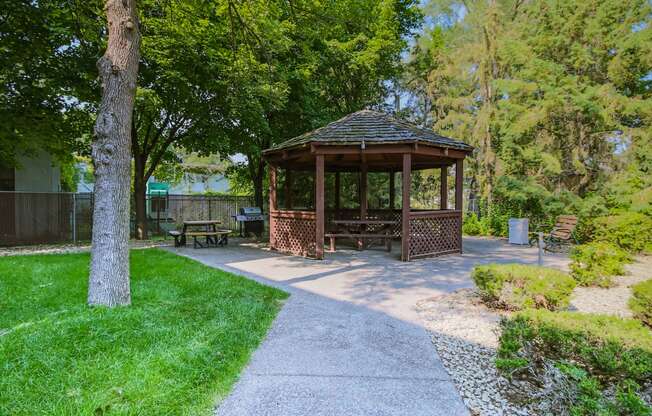 Anoka, MN Dellwood Estates Apartments. a gazebo in a park with trees