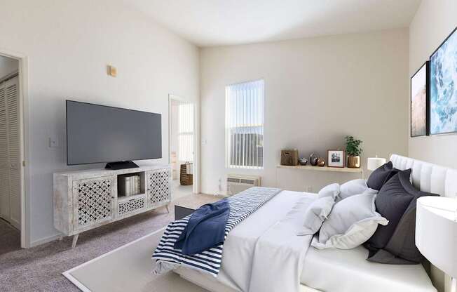 A bedroom with a bed, a television, and a window with blinds.