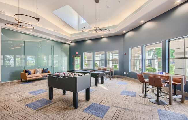 a game room with a foosball table and a pool table