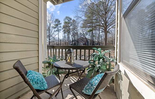 a patio with a table and chairs on a balcony