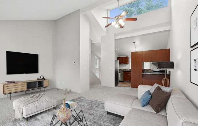 A living room with a white couch and a flat screen TV.