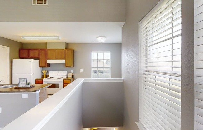 A view of a kitchen with a counter and a window