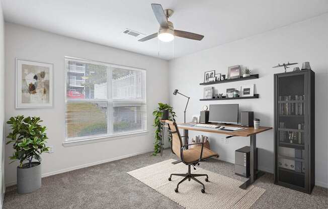 2 & 3-Bedroom Apartments for Rent in Little Rock, AR – Capitol Hill – A room with a desk, chair, and a ceiling fan.