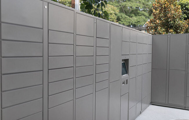 A wall of grey lockers with a door on the side.