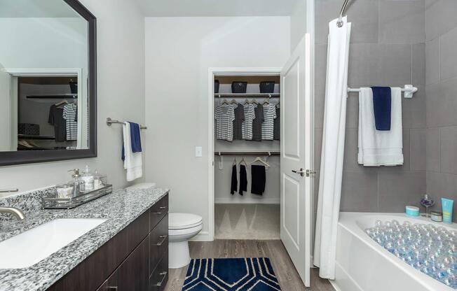 a bedroom area with a sink and a mirror
