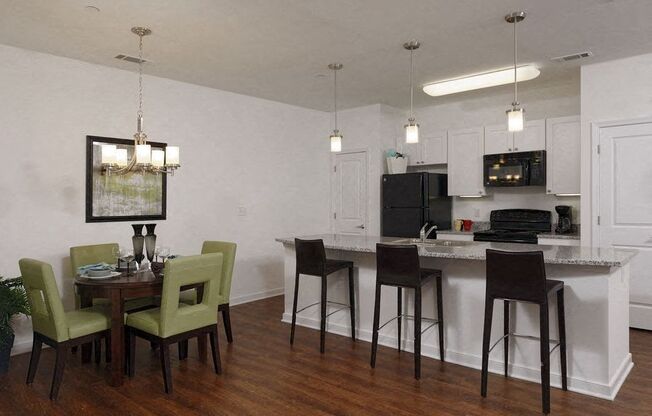 a kitchen and dining room with a table and chairs