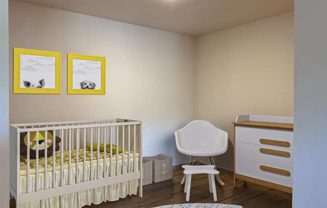 A baby room with a crib, chair, and pictures on the wall.