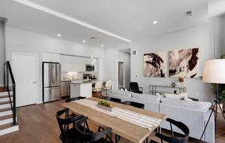 A modern kitchen with a dining table and chairs.