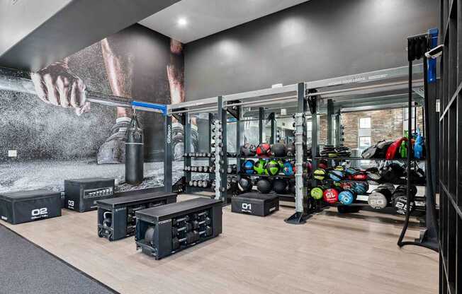 A gym with a variety of equipment including weights and weight racks. at The Laurel Apartments, Chandler, AZ