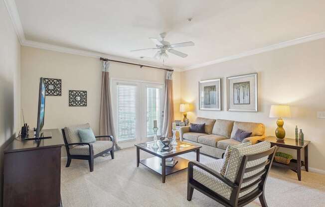 A living room with a sofa, armchair, and coffee table.