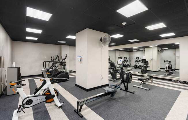 a gym with exercise equipment and weights in a building