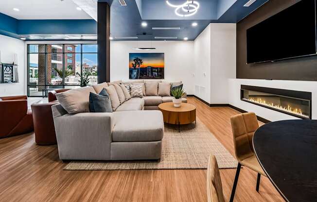 A modern living room with a fireplace and a large couch.