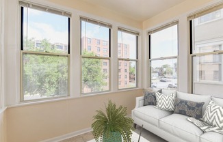 sunroom with sofa, coffee table and large windows at twin oaks columbia heights washington dc