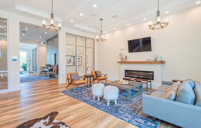 a living room with two sheep in front of a fireplace
