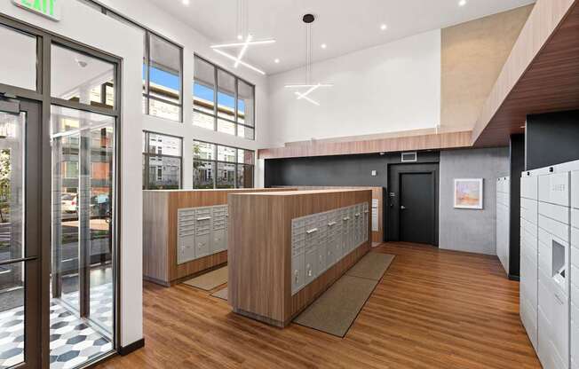 A reception area with a wooden counter and a black door.