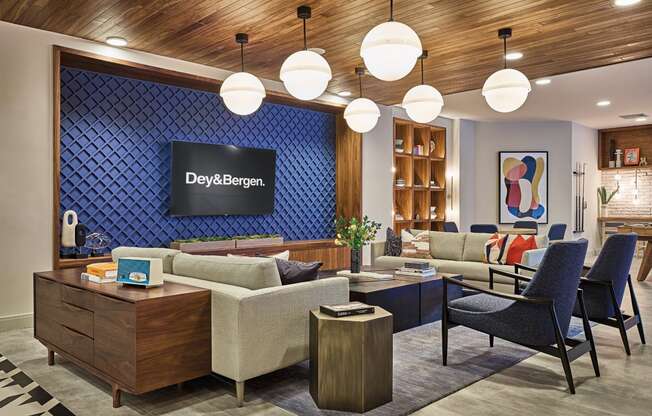 a lobby with couches chairs and tables and a television at Dey & Bergen, Harrison, New Jersey