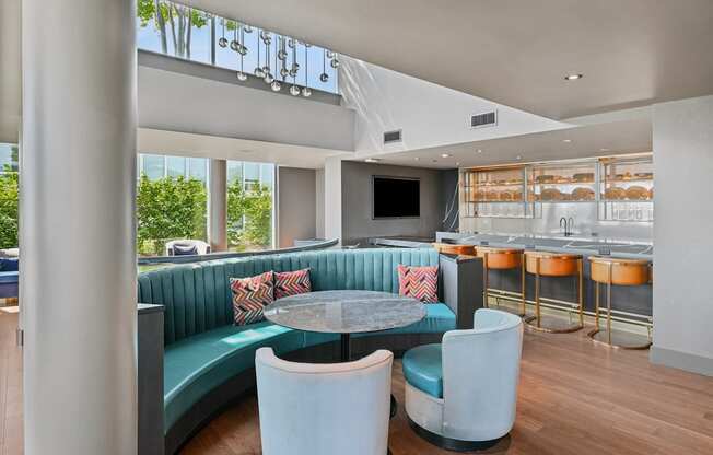 A modern dining area with a round table and blue chairs.