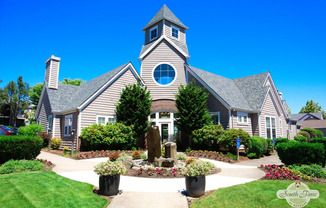 the front yard of a house with a garden and a church