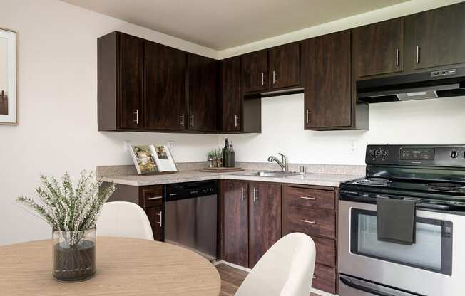 our apartments offer a kitchen and dining area with a table