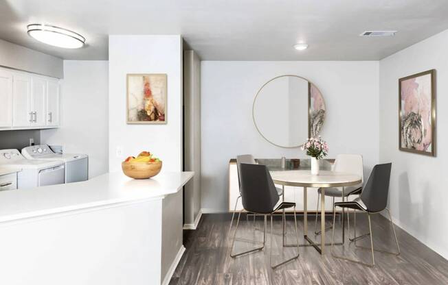 a dining room with a table and chairs and a kitchen