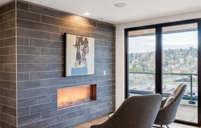 A modern living room with a fireplace and a painting on the wall.