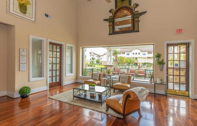 a living room filled with furniture and a large window