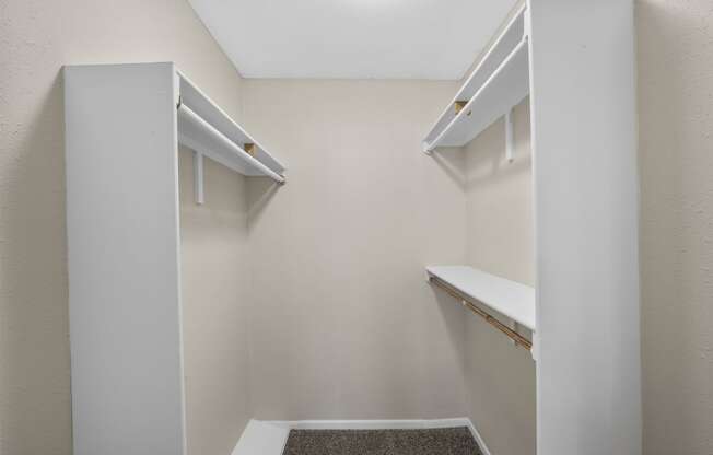 a spacious walk in closet in a home with white shelves and white walls at Brookside Apartments, Texas, 76643