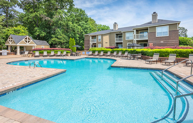 Large Outdoor Pool With Sun Lounge Chairs On The Sundeck