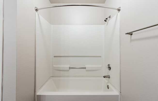 a bathroom with a white bathtub and a white shower curtain